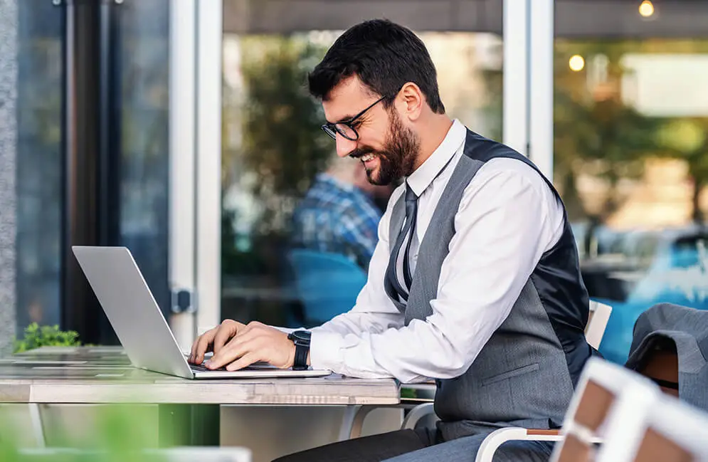 Creative technology-driven digital solutions banner by Miruthika Enterprises featuring a professional working on a laptop in a modern office.