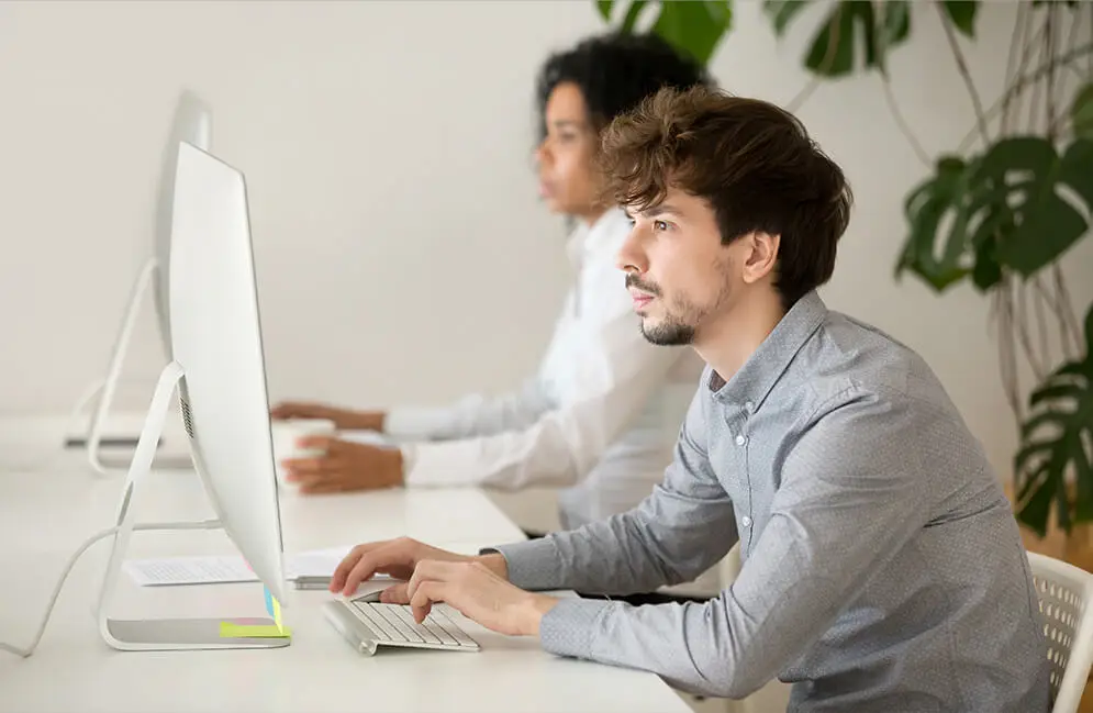 Your trusted digital growth partner website banner by Miruthika Enterprises showing a team discussing analytics on a desktop computer.